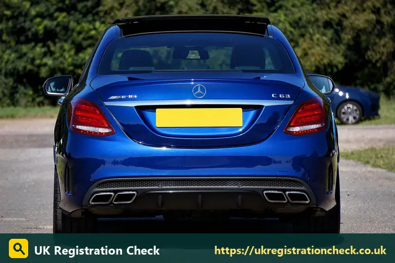 Rear of a blue saloon with a yellow number plate - car registration n