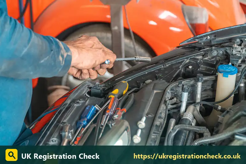 Mechanic's hands working on parts in an engine bay - check fuel type by reg