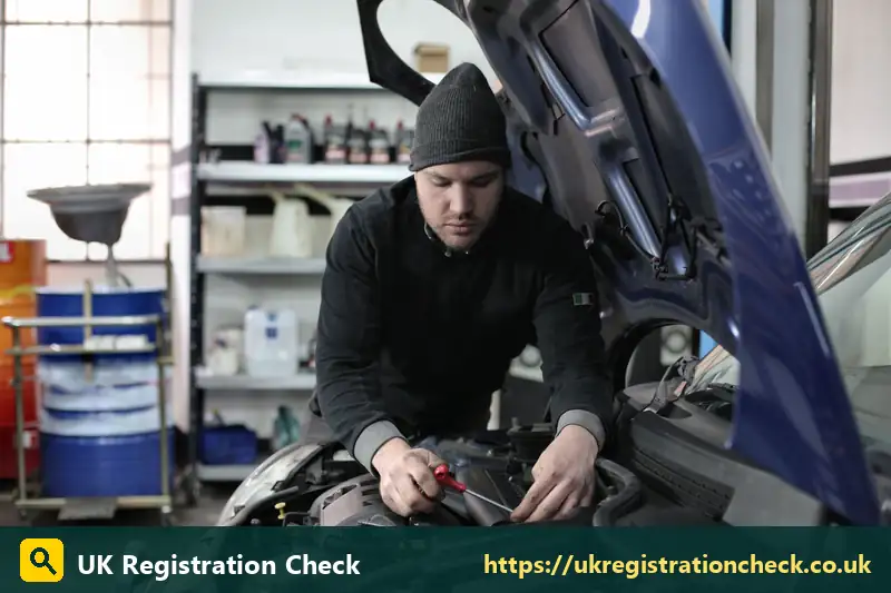 Mechanic working on a blue car engine in a garage - is my car euro 6