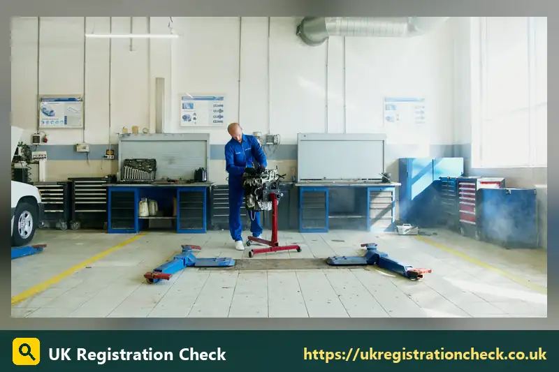 Garage workshop with a mechanic and an engine on a stand - mot and service cost