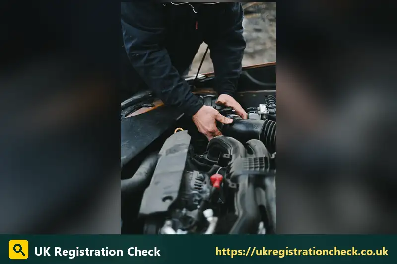 Hands working on a car engine - vehicle oil checker