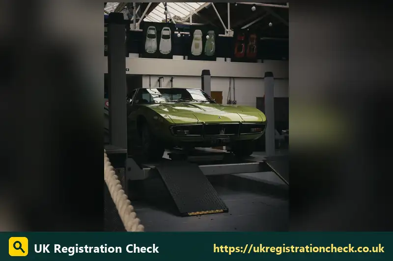 Classic green sports car raised on a garage ramp - what is auto registration