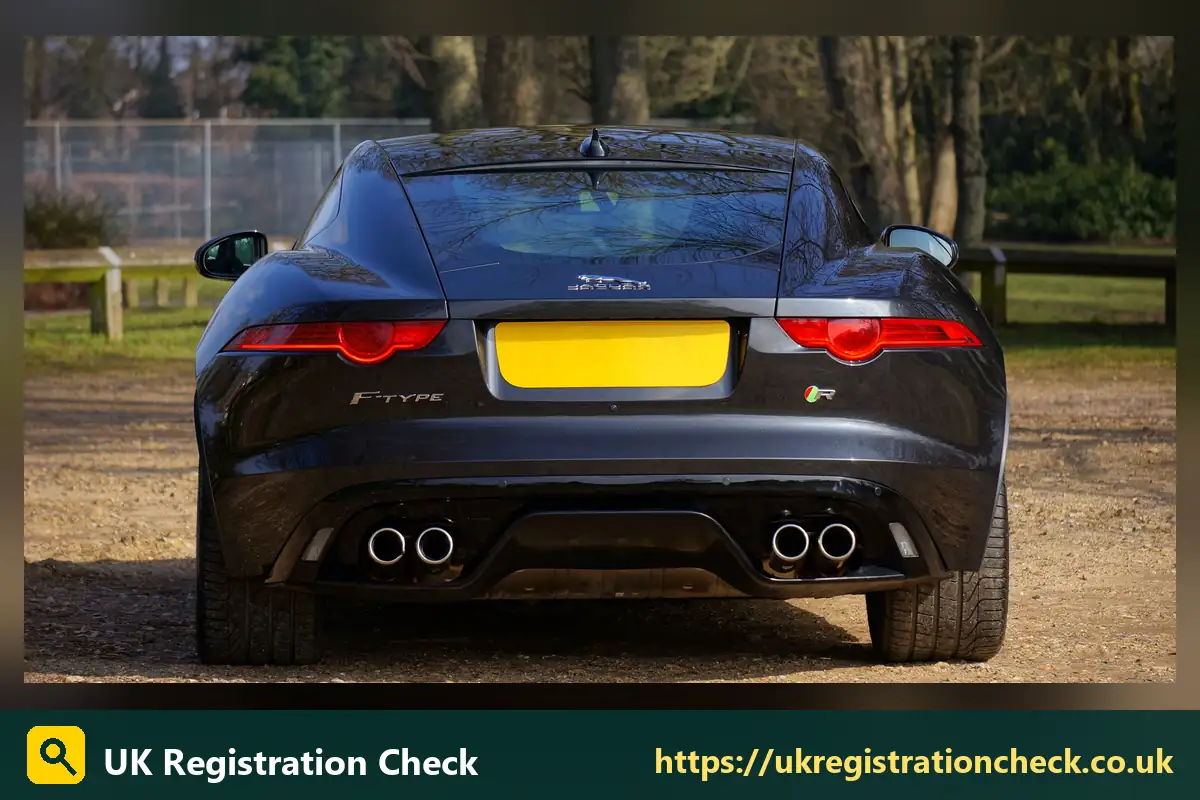 Rear of a dark coupe with a yellow number plate - bmw number plates