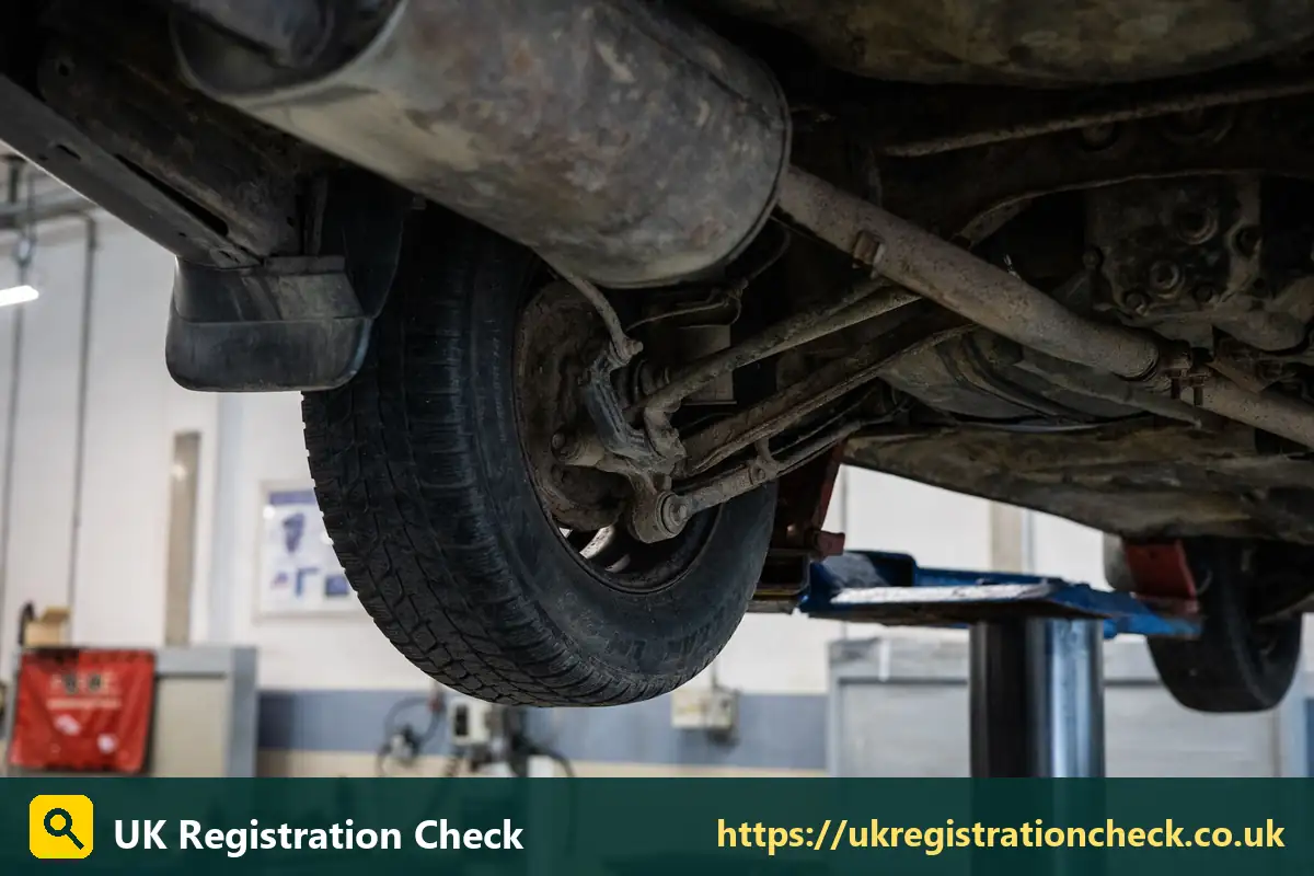 Exhaust and suspension underneath a car on a lift - mot history